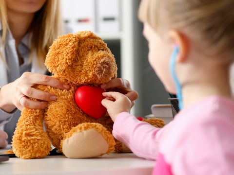 Little child at pediatrician reception listen