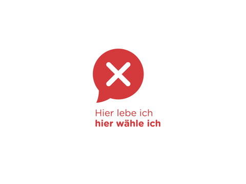 Logo der Symbolwahl: rote Sprechblase mit Wahlkreuz und dem Schriftzug „Hier lebe ich, hier wähle ich“