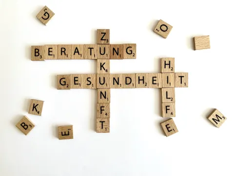 Scrabble-Buchstaben bilden die Worte Beratung, Zukunft, Hilfe und Gesundheit
