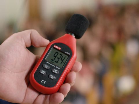 Decibelometer close-up. Stock footage. Measurement of sound volume in the audience. Experiment. Sound level meter
