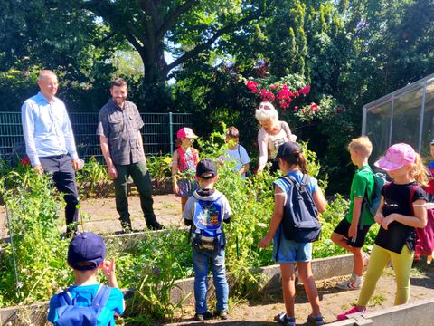 v.l.n.r.: Tobias Dollase (Schulstadtrat), Peter Wunderlich (Gärtner), Conny Muschikowski (Horterzieherin) und Ferienhortkinder der Grundschule am Fließtal. (Bild: BA Reinickendorf)
