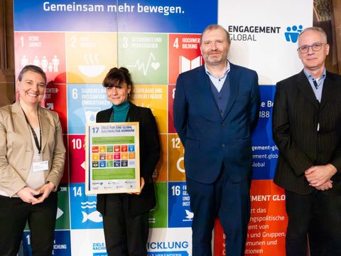 Urkundenübergabe 10. Vernetzungstreffen des Clubs der Agenda 2030 Kommunen von Niels Albers (Bereichsleiter, Servicestelle Kommunen in der Einen Welt von Engagement Global), Anne Bolling (Referentin, Bundesministerium für wirtschaftliche Zusammenarbeit und Entwicklung) und Marcell Moll (Wiss. Mitarbeiter, Europa/Internationales, Deutscher Städtetag) an Jane Krüger, Koordinatorin für kommunale Entwicklungspolitik in Reinickendorf.
