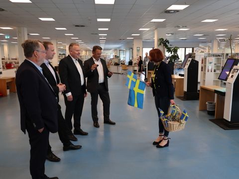 22. Mai 2026: Herzliche Begrüßung der schwedischen Delegation mit blau-gelben Fähnchen: Inken Meseck-Lude, stellvertretende Leiterin der Ingeborg-Drewitz-Bibliothek