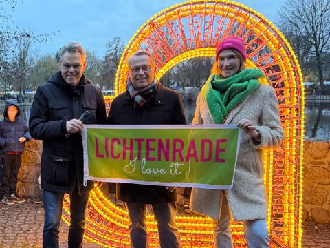 Bezirksbürgermeister Oltmann, BVV-Vorsteher Böltes und Künstlerin Beathe Kothe vor einem Leuchtherz