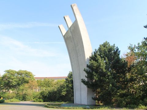 a large monument on a leafy square