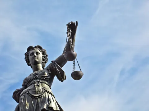 Skulptur von Themis, Femida oder Gerechtigkeit Göttin auf strahlend blauem Himmel