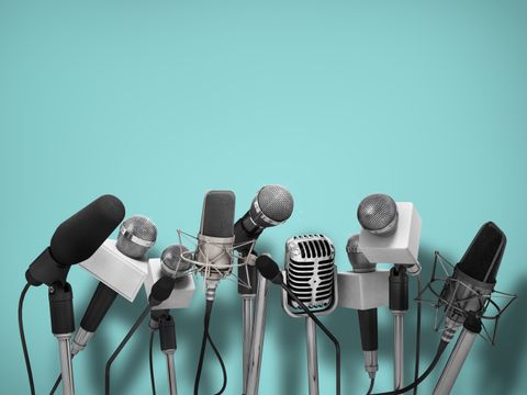 Press conference with standing microphones.