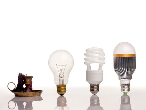 Fortschriftt der Beleuchtung - Kerze, Glühlampe, Energiesparlampe und eine LED-Lampe