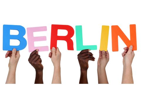 Hände von multikultureller Menschen-Gruppe halten die Buchstaben für das Wort Berlin hoch
