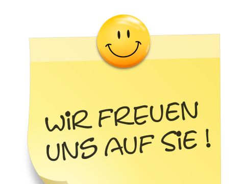Zettel mit Aufschrift "Wir freuen uns auf Sie"