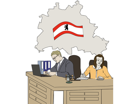 Mann und Frau arbeiten in einem Büro mit einer Berlin-Flagge im Hintergrund