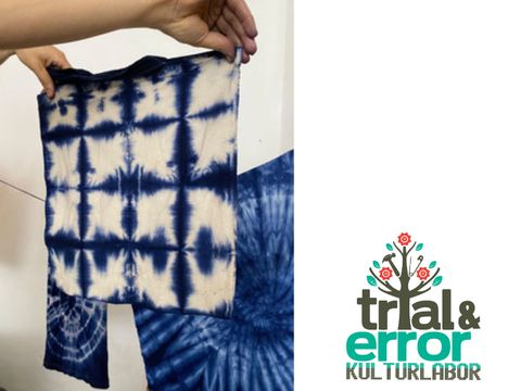Foto eines blau gebatikten Stück Stoffes / Logo trial & error Kulturlabor