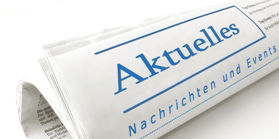 Zusammengerollte Zeitung; auf der Vorderseite steht mit großer Schrift "Aktuelles"