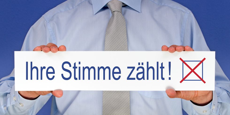 Mann hält Schild mit Schriftzug Ihre Stimme zählt