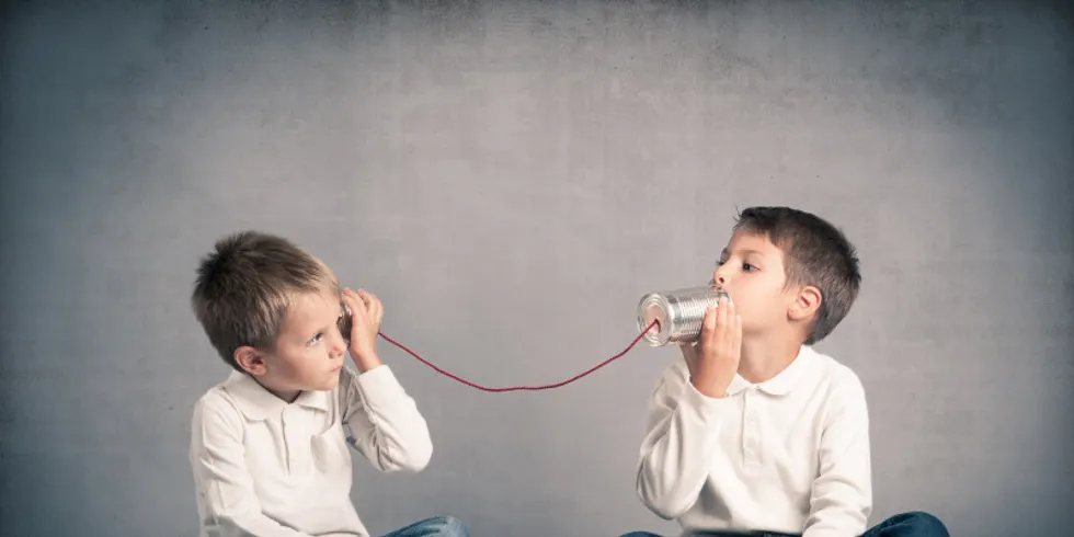 Zwei Brüder telefonieren, indem sie Blechbüchsen an ihre Ohren halten.