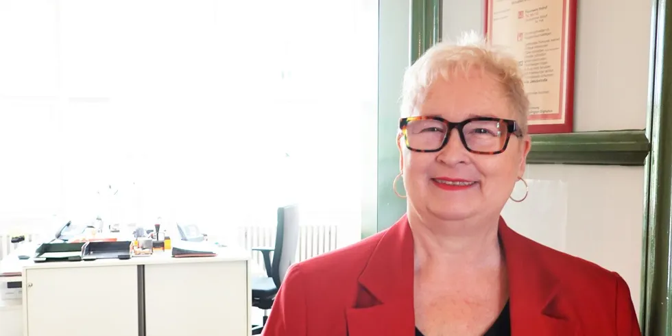 Eine Frau steht an einer offenen Bürotür