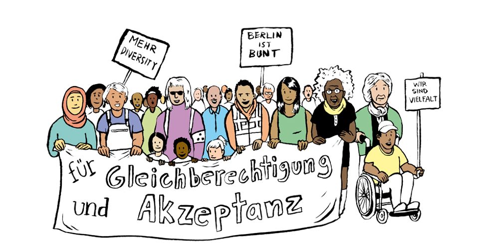 Eine diverse Gruppe an Menschen mit Schildern und einem Transparent