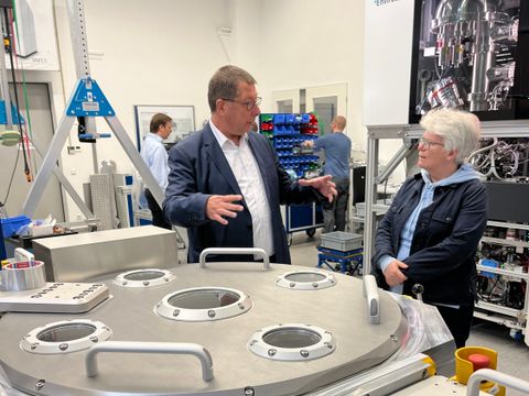 Geschäftsführer Dr. Andreas Thissen zeigt Bezirksbürgermeisterin Stefanie Remlinger die Produktionsräume der Firma SPECS Surface Nano Analysis GmbH