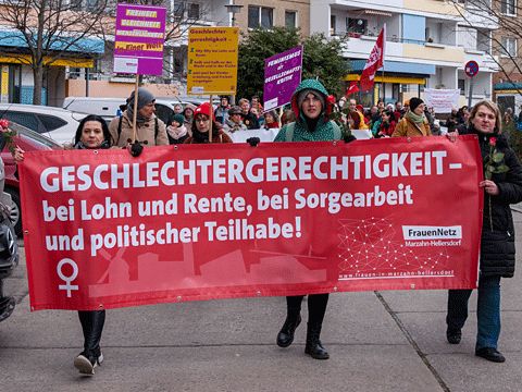 Frauen tragen ein Banner mit der Aufschrift Geschlechtergerechtigkeit - bei Lohn und Rente, bei Sorgearbeit und politischer Teilhabe