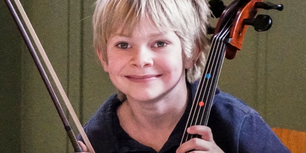Glücklicher Junge mit Cello.