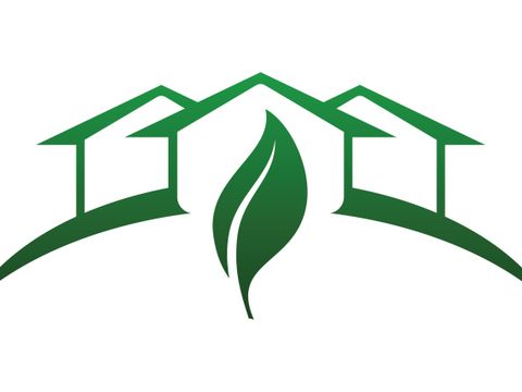 Häuser-Piktogramm mit grünem Blatt