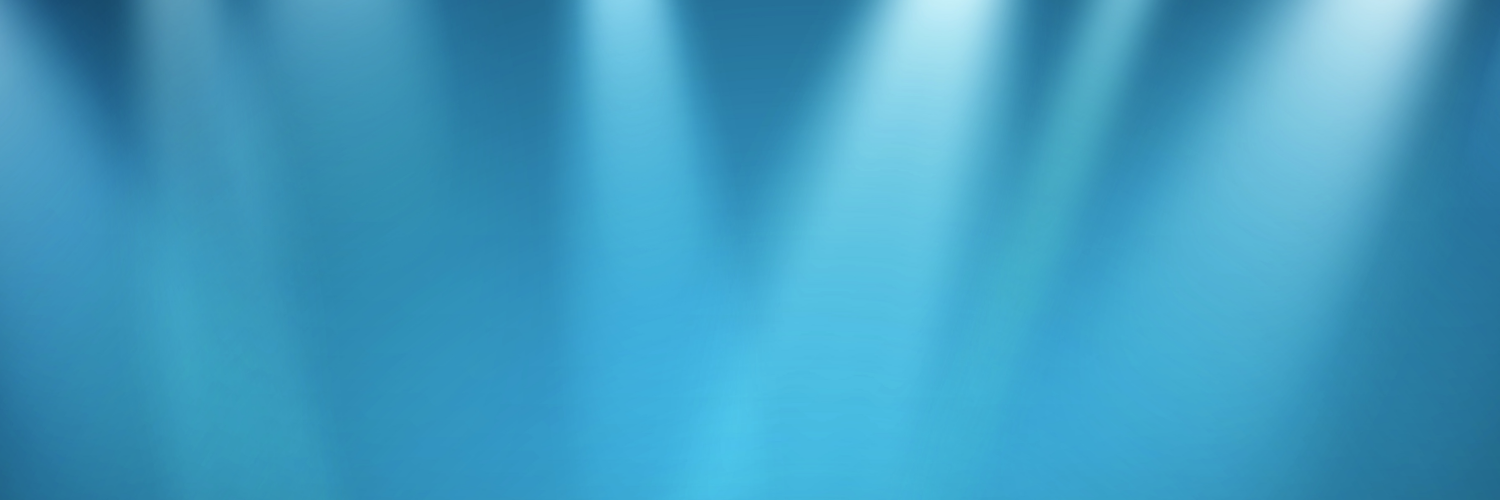 Blauer Hintergrund mit Licht, das vom oberen Bildrand aus vielen Scheinwerfern wie auf eine Bühne geworfen wird