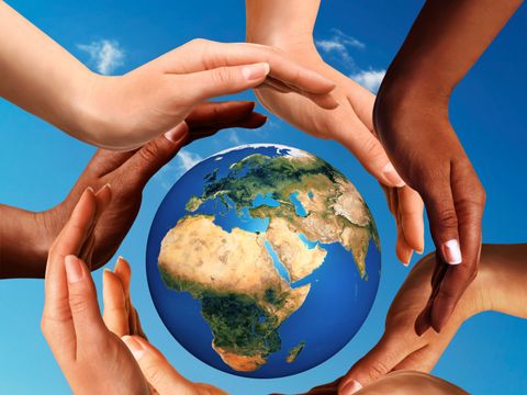 Multiracial Hands Together Around World Glob