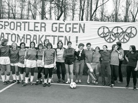 Bildvergrößerung: Viele Frauen in Sportbekleidung stehen vor einem Plakat mit der Aufschrift "Sportler gegen Atomkraft"