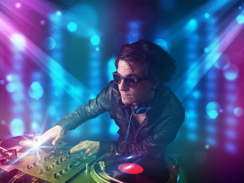 DJ mixt Musik in einem Club mit blauem und lila Licht