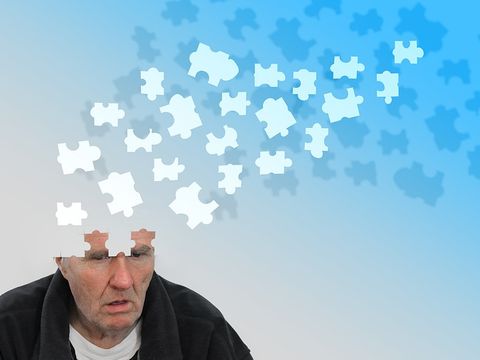 Symbolfoto Demenz einem älteren Herrn fliegen Puzzleteile aus dem Kopf