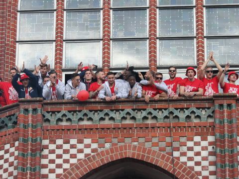 Bildvergrößerung: Die Mannschaft des 1. FC Union Berlin jubelt auf dem Balkon des Rathauses Köpenick den Fans zu