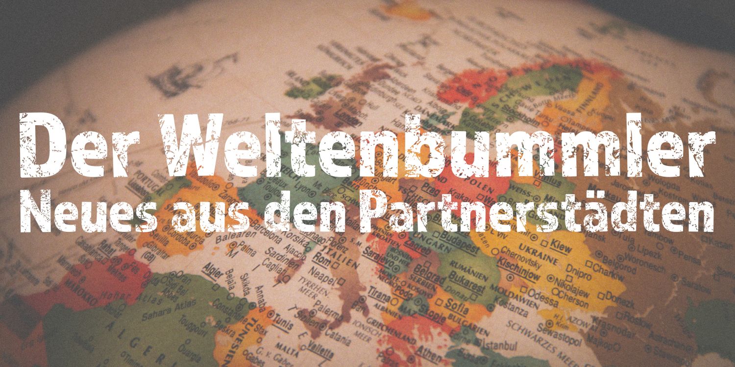 Der Weltenbummler - Neues aus den Partnerstädten (Schriftzug auf einer mehrfarbigen Landkarte, welche mehrheitlich Europa zeigt)