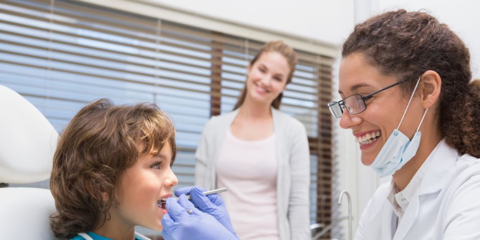 Zahnärztin untersucht kleinen Jungen